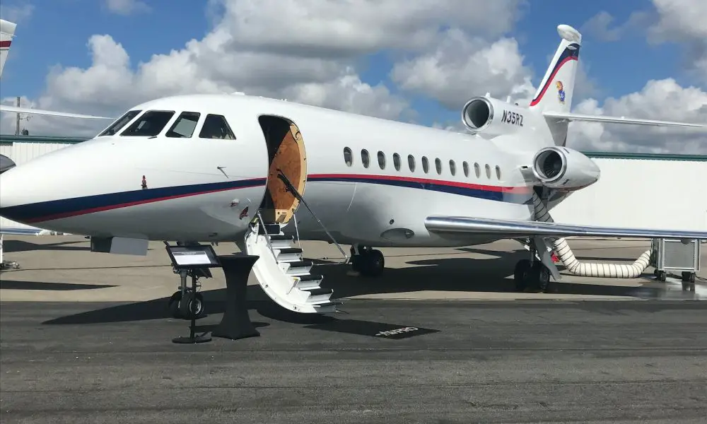 white airliner on gray pavement