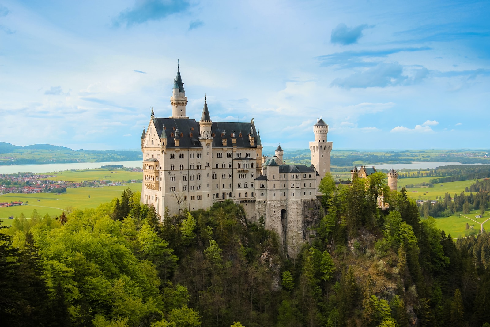 white and gray castle on top of hill