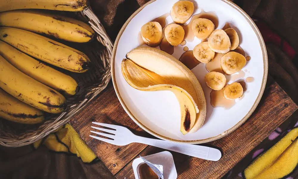 sliced ripe banana on round white ceramic plate