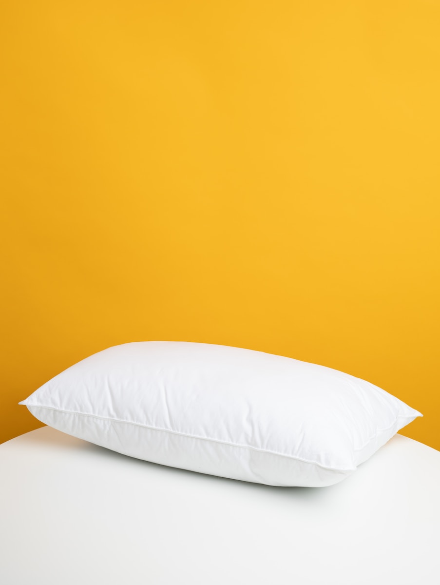 white pillow on white bed