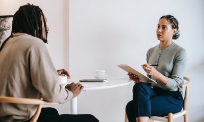 Ethnic female psychotherapist listening to black clients explanation