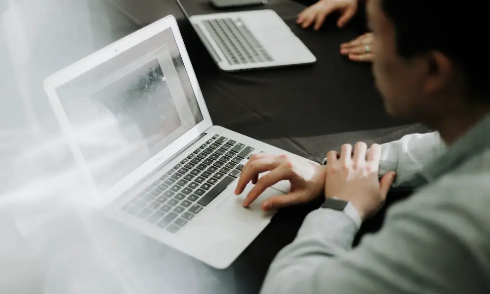 a man sitting in front of a laptop computer