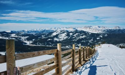 snowfield and brown wooden fence near mountain at daytime