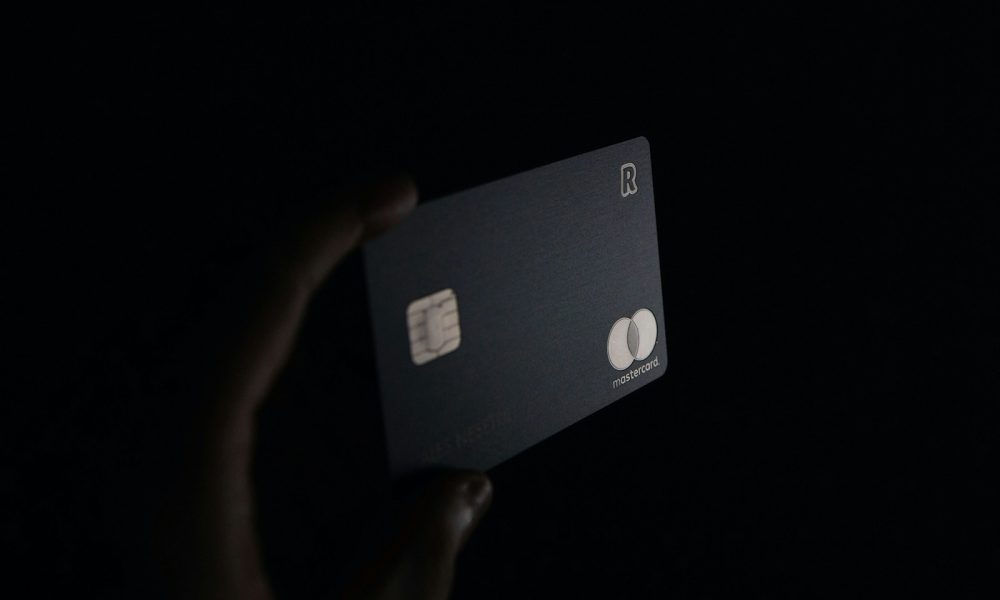 person holding black card