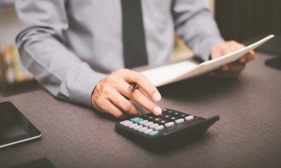 businessman uses calculator for profit loss review 462557409 bigstock scaled