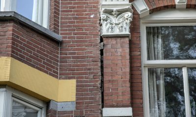 crack between residential buildings in amsterdam bloomberg scaled