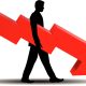 1752982828 bigstock Financial Failure downgrade businessman holding downward arrow 6816196