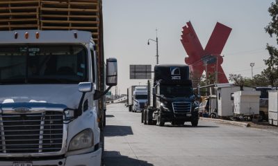 tractor trailers cross US Mexico border in juarez mexico bloomberg scaled