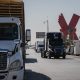 tractor trailers cross US Mexico border in juarez mexico bloomberg scaled