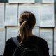 AdobeStock 1170138657 Student scanning job listings board search for meaningful employme scaled