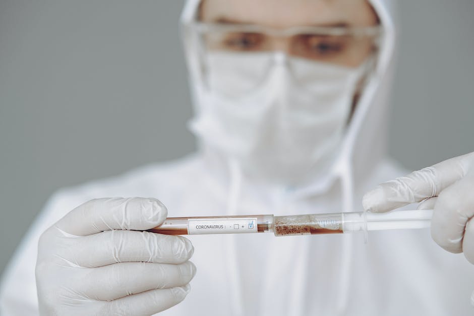 Image depicting a phlebotomist taking a blood sample from a patient.